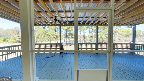 a view of a room with wooden floor