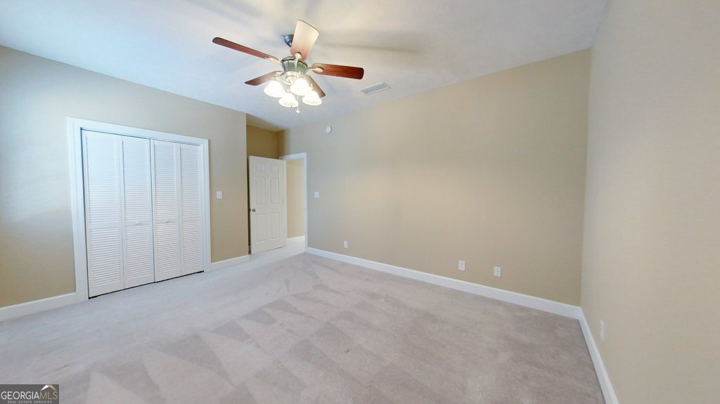 101 Willow Ridge Circle Thomasville, GA 31757 - Photo 65 of 92 an empty room with a chandelier fan and windows