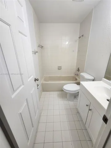 a bathroom with a sink a toilet a mirror and shower