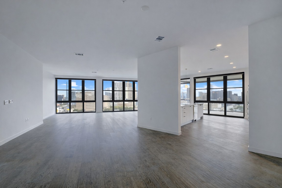 800 Embassy Drive, Unit 606 Austin, TX 78702 - Photo 11 of 38 a view of an empty room with wooden floor and a window