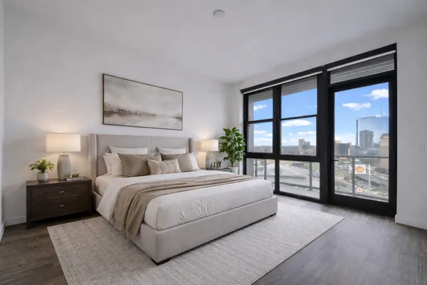 a bedroom with a large bed and a large window