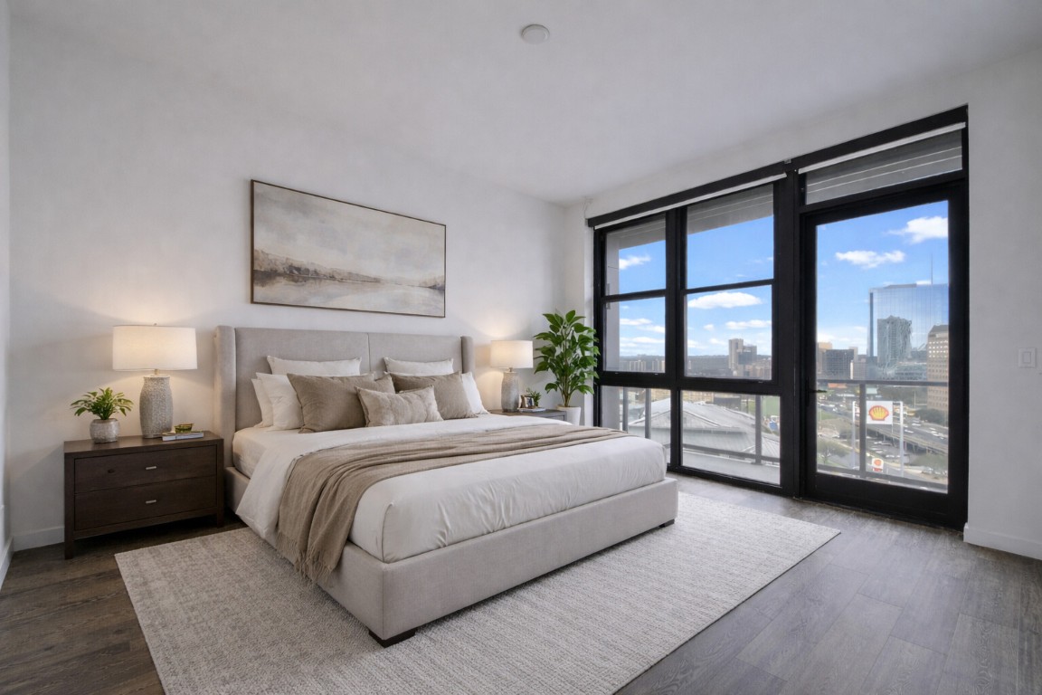 800 Embassy Drive, Unit 606 Austin, TX 78702 - Photo 14 of 38 a bedroom with a large bed and a large window