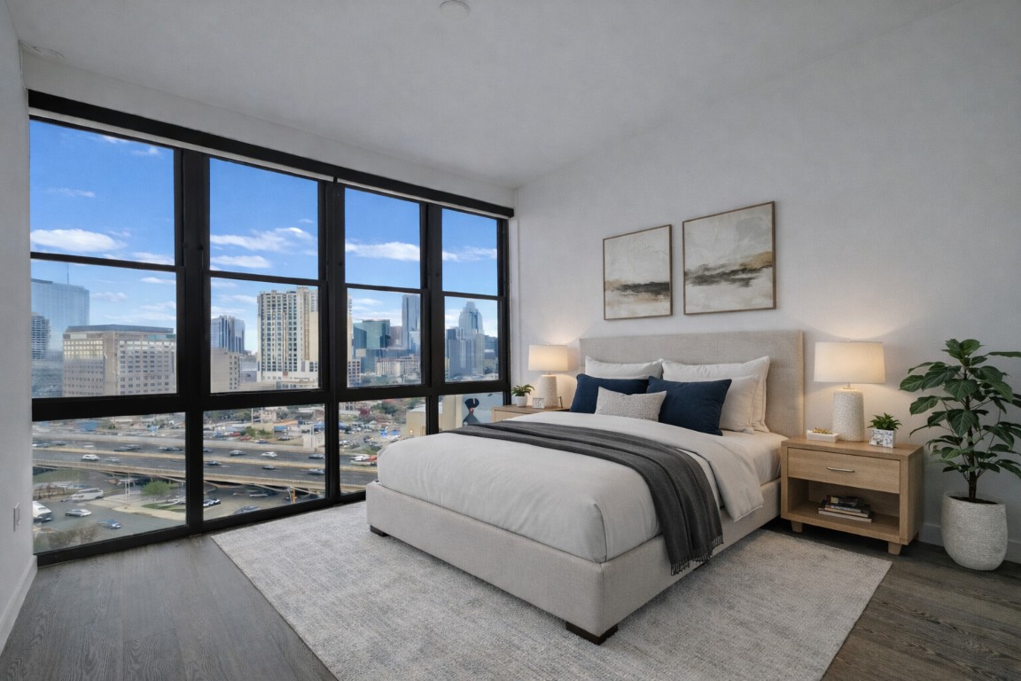 800 Embassy Drive, Unit 606 Austin, TX 78702 - Photo 20 of 38 a bedroom with a large bed and a large window