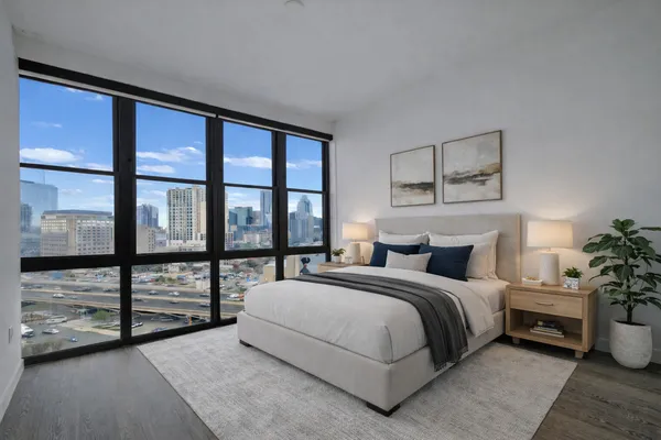 a bedroom with a large bed and a large window