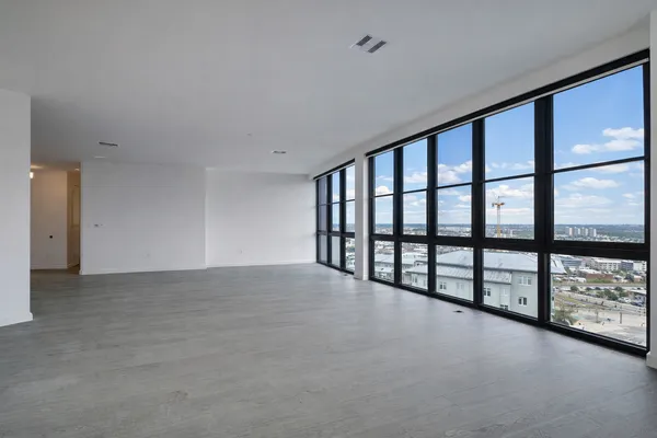 a view of an empty room with windows