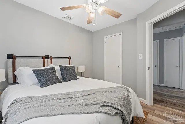 a bedroom with a bed and ceiling fan