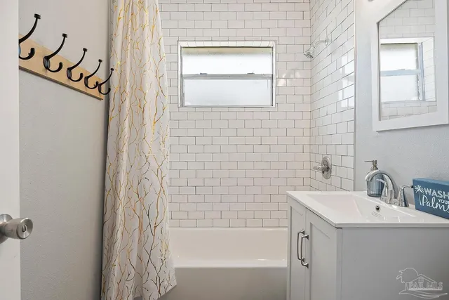 a bathroom with a sink a mirror and a bathtub