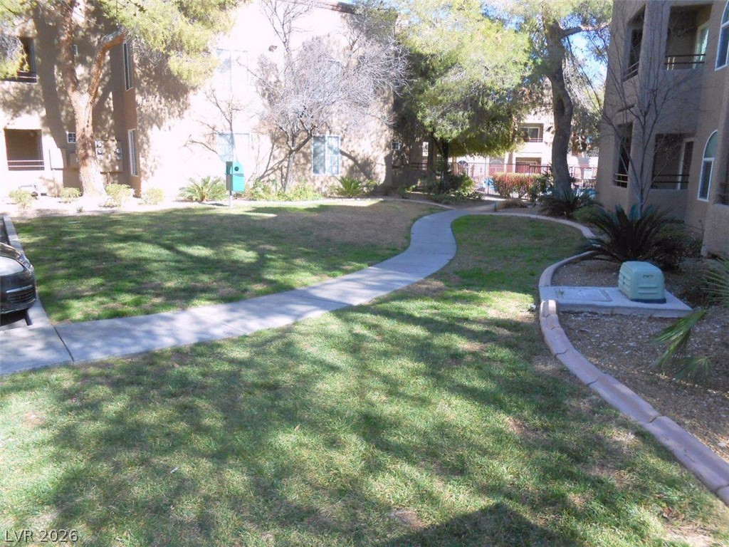 9325 West Desert Inn Road, Unit 132 Las Vegas, NV 89117 - Photo 20 of 36 Meandering pathways connect verdant green spaces within this community setting.