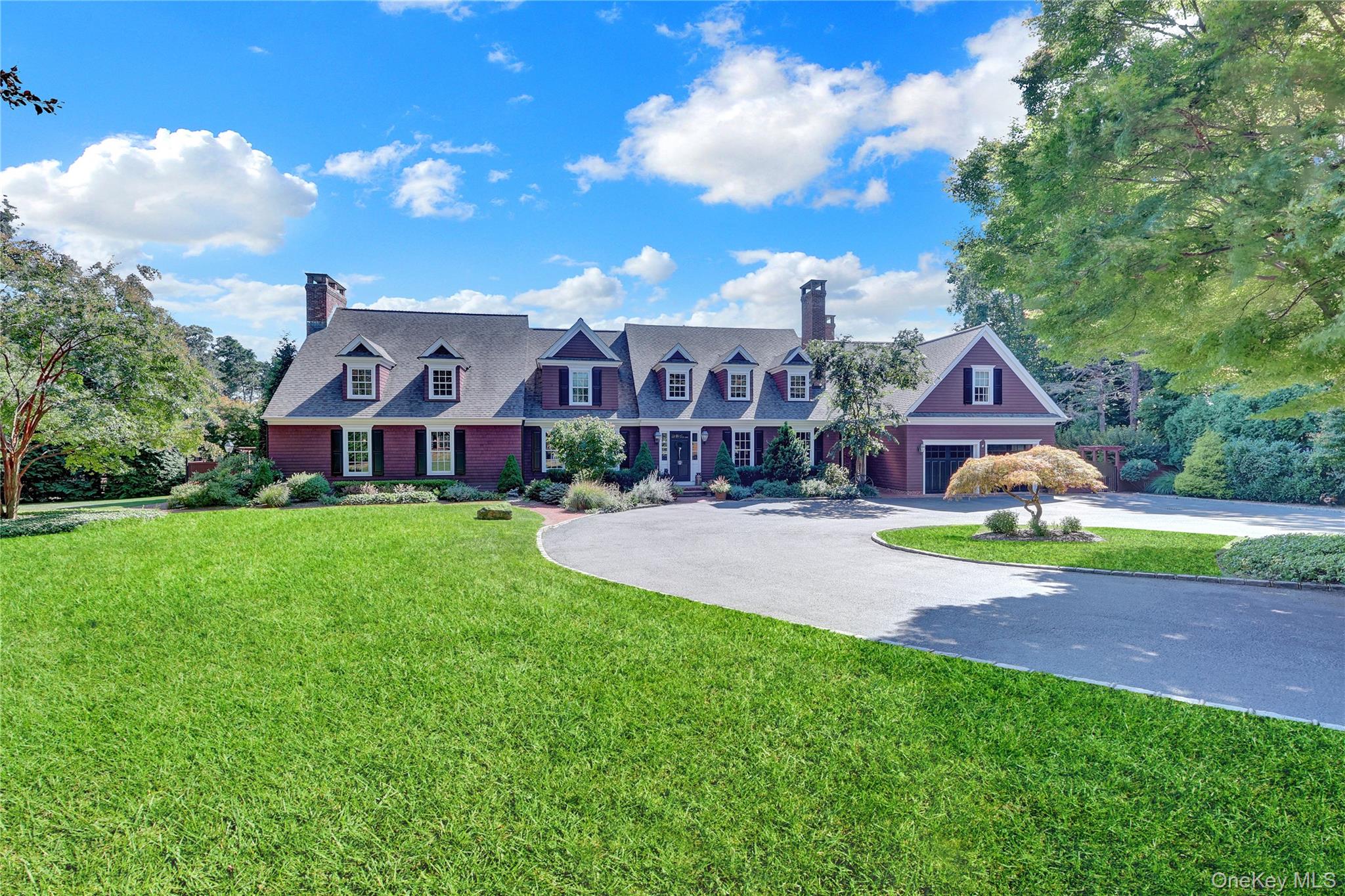 63 Dyke Road Setauket, NY 11733 - Photo 49 of 49 Cape cod house featuring a chimney, curved driveway, a front yard, and a garage