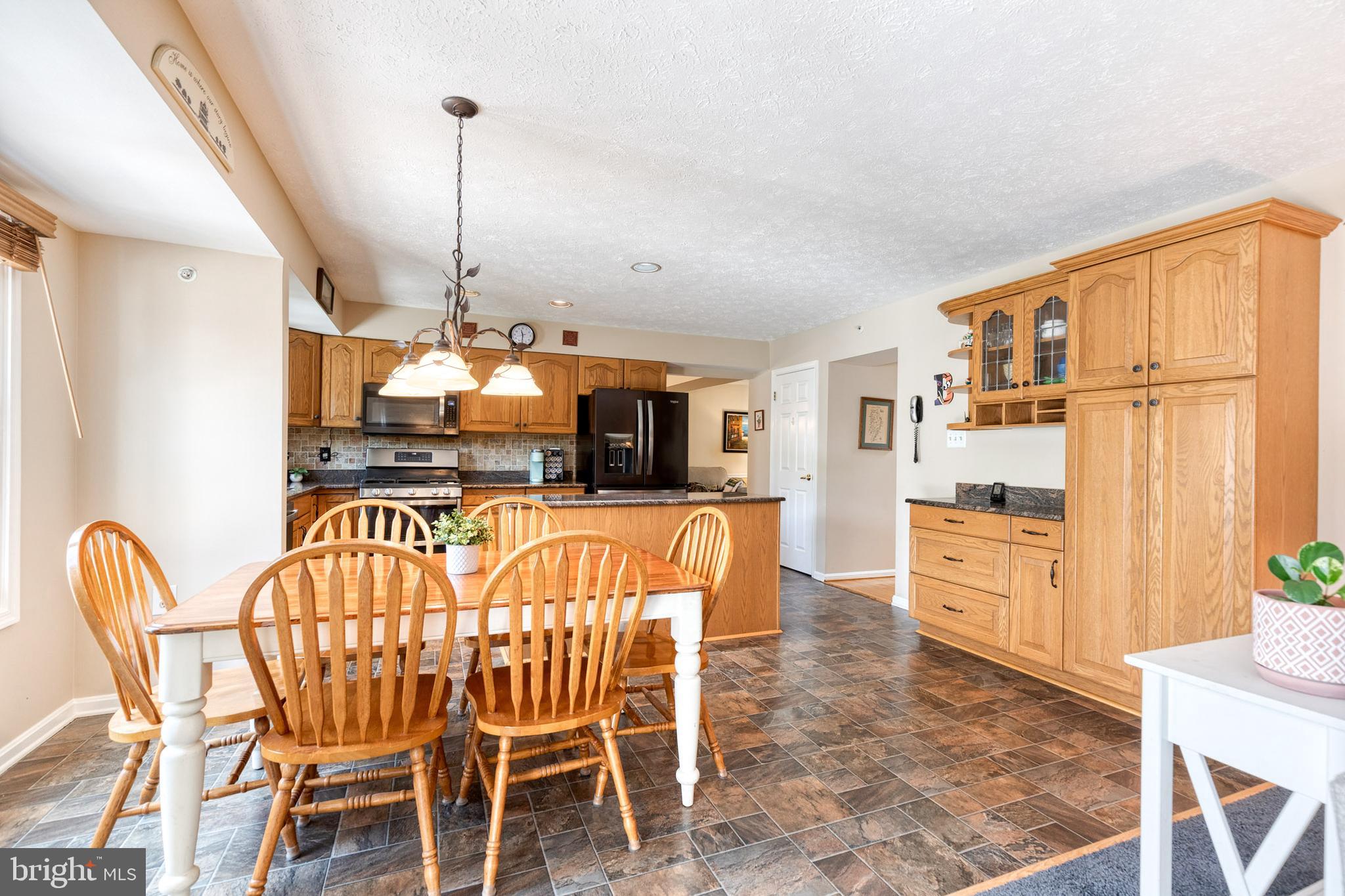 16 Perry Ridge Court Baltimore, MD 21237 - Photo 16 of 45 a dining room with furniture a chandelier and wooden floor