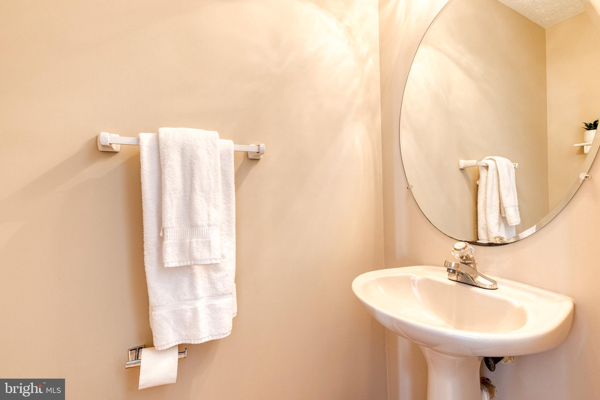 16 Perry Ridge Court Baltimore, MD 21237 - Photo 20 of 45 a bathroom with a sink and a mirror