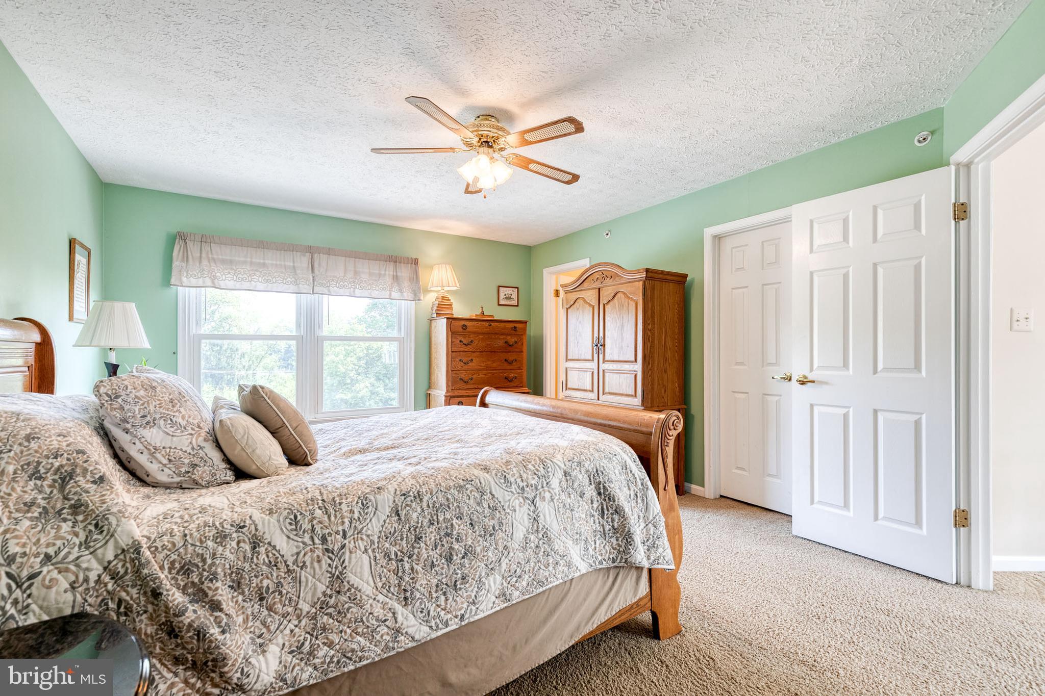 16 Perry Ridge Court Baltimore, MD 21237 - Photo 22 of 45 a bedroom with a large bed and a window