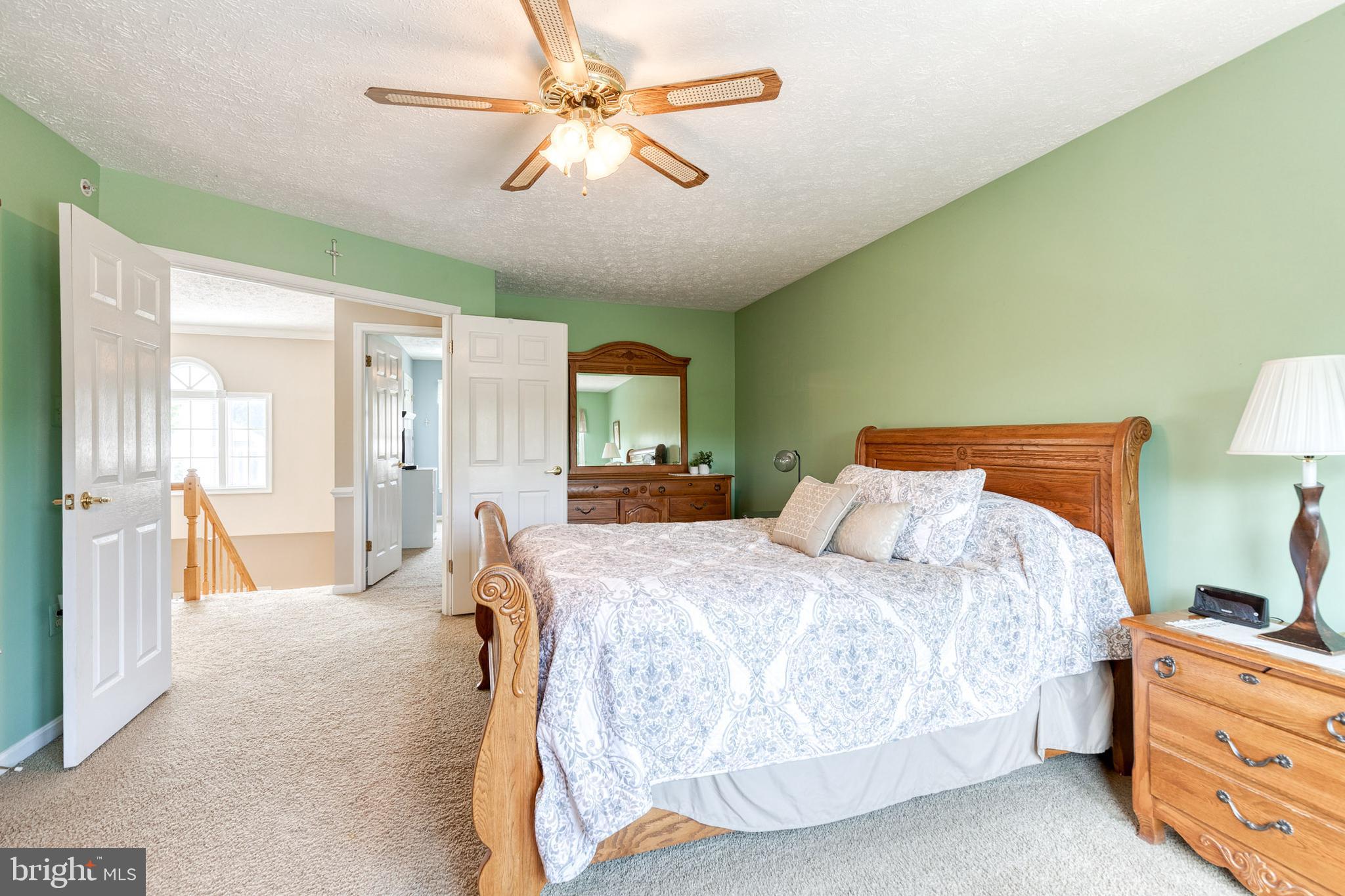 16 Perry Ridge Court Baltimore, MD 21237 - Photo 23 of 45 a bedroom with a bed and a chandelier