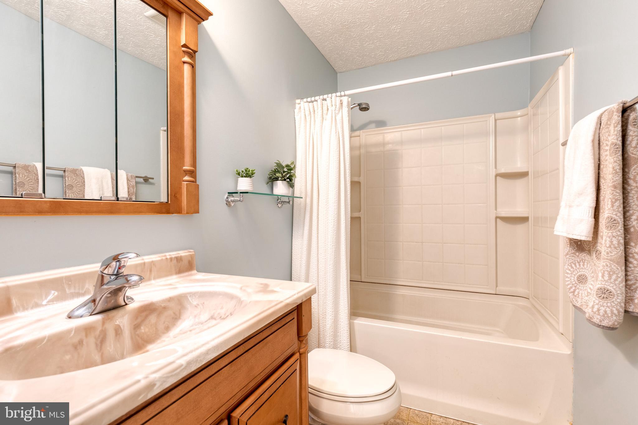 16 Perry Ridge Court Baltimore, MD 21237 - Photo 30 of 45 a bathroom with a granite countertop sink toilet and shower