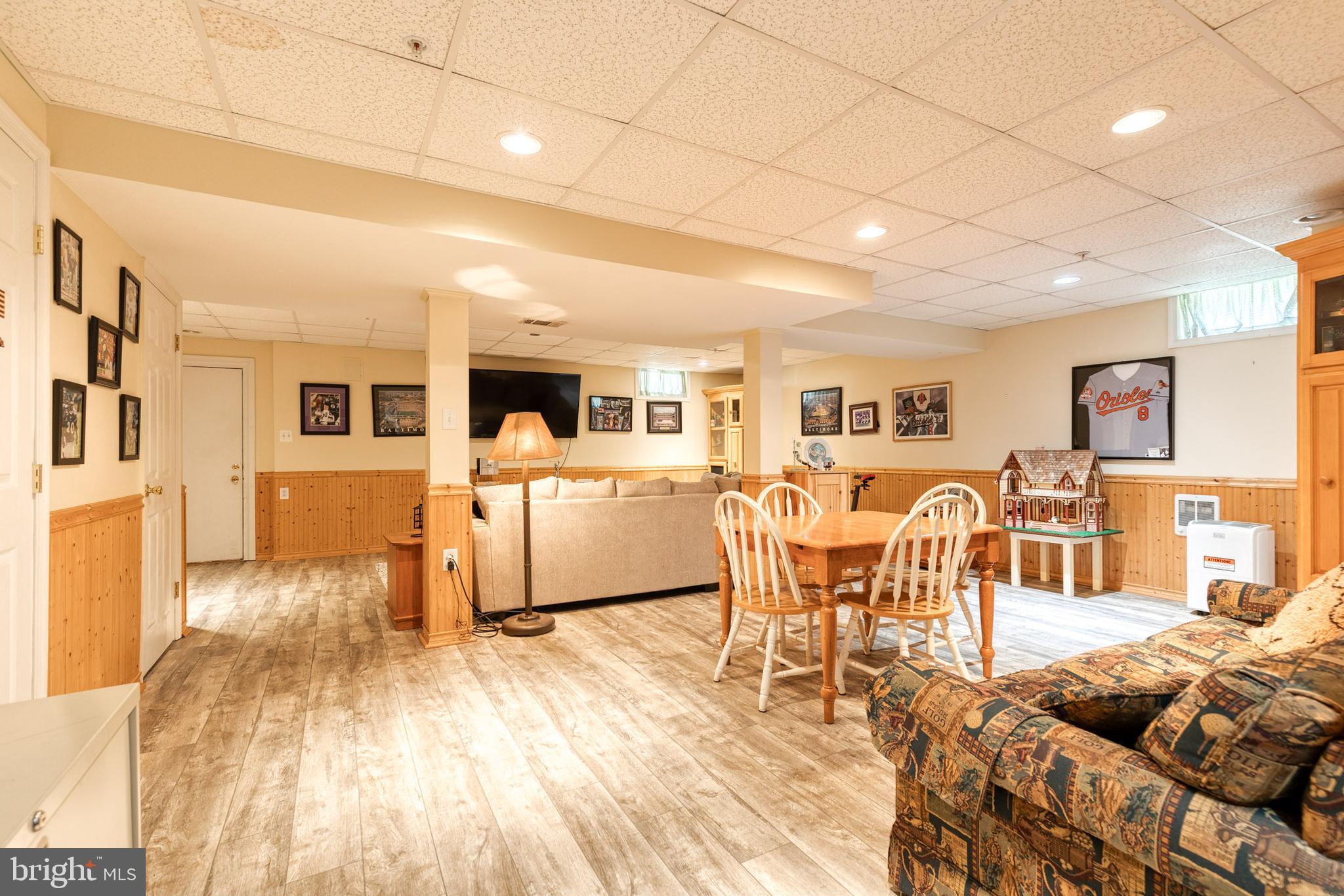 16 Perry Ridge Court Baltimore, MD 21237 - Photo 32 of 45 a living room with furniture a wooden floor and a kitchen view