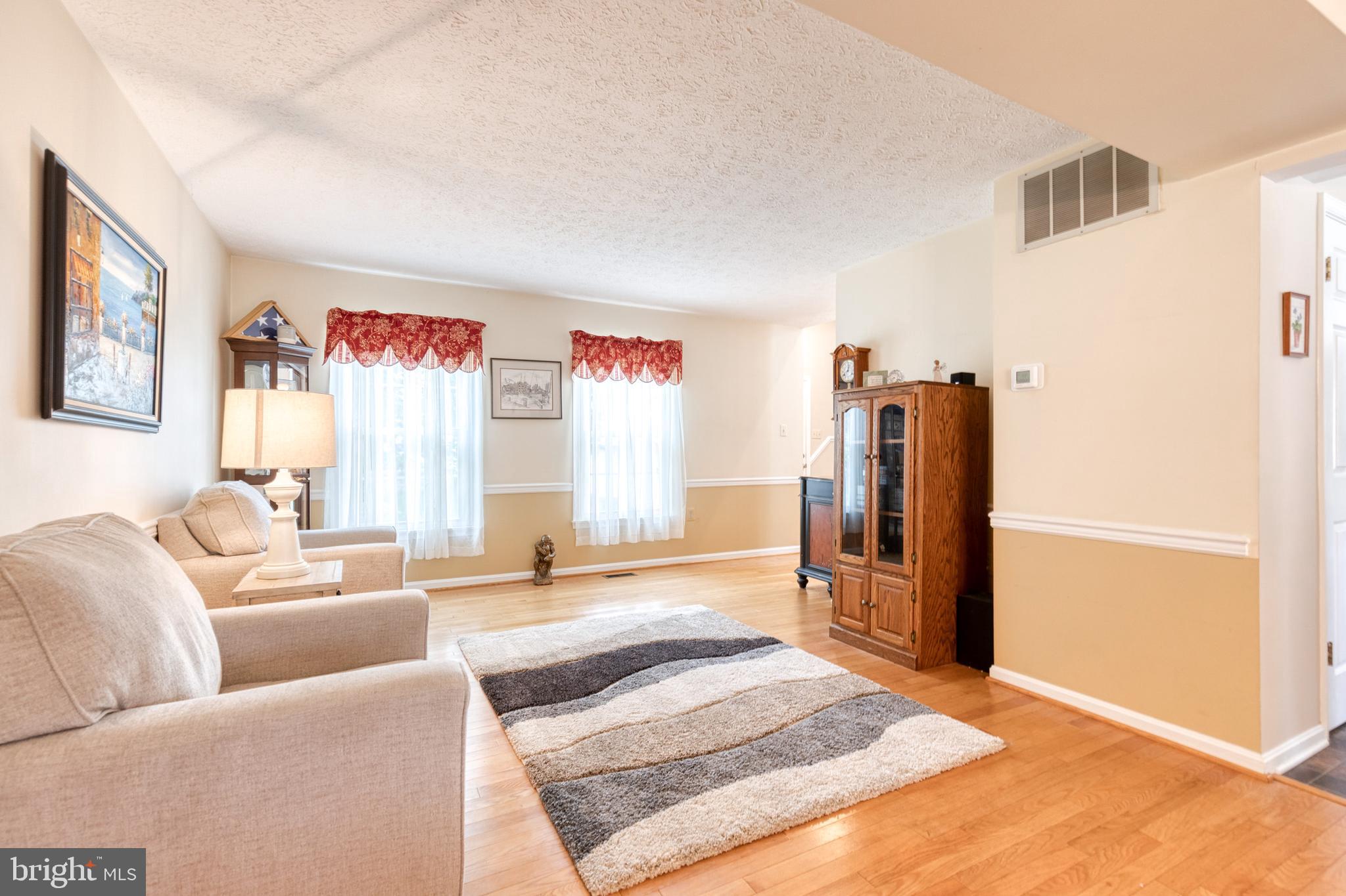 16 Perry Ridge Court Baltimore, MD 21237 - Photo 5 of 45 a living room with furniture and a flat screen tv