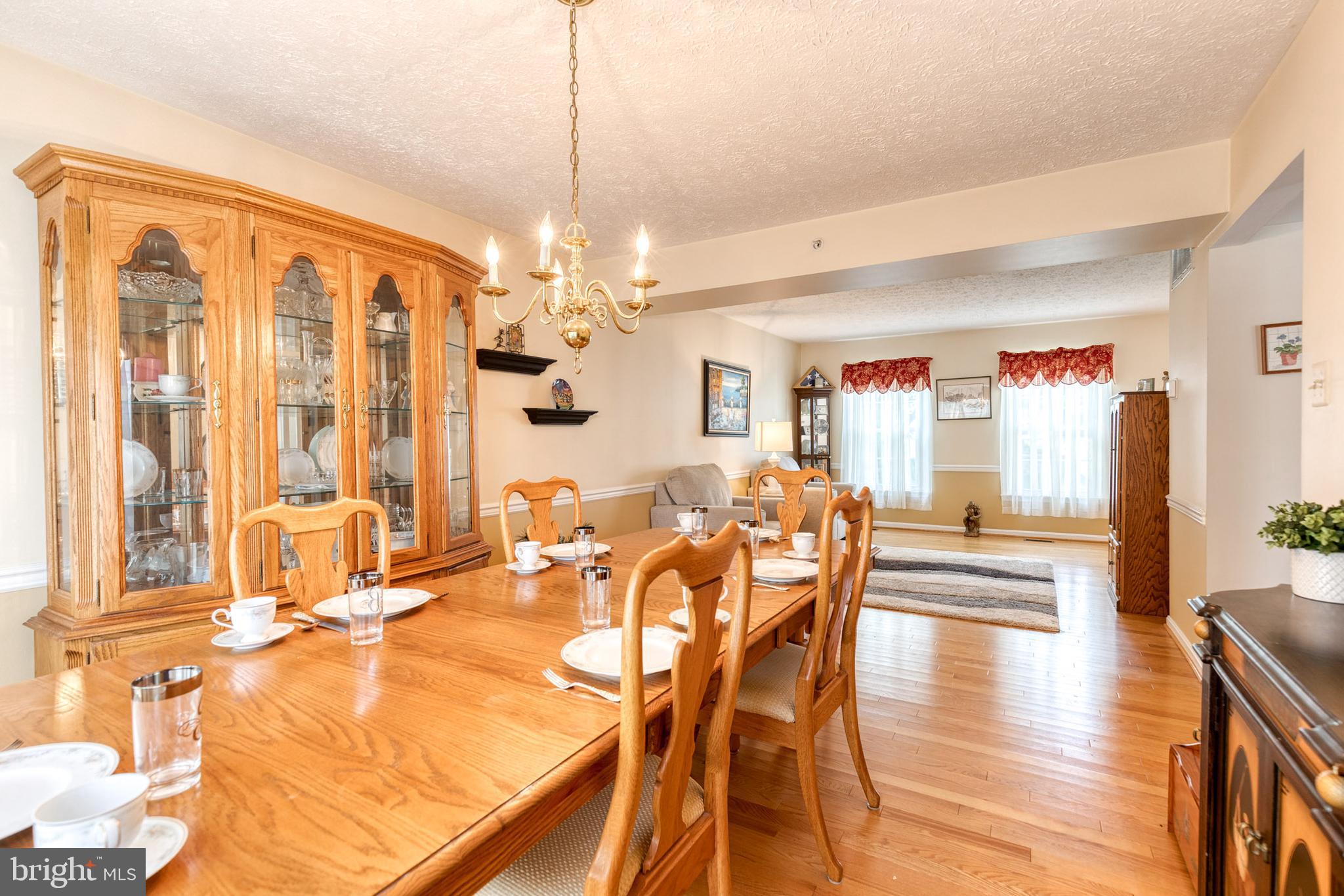 16 Perry Ridge Court Baltimore, MD 21237 - Photo 8 of 45 a view of a dining room and livingroom with furniture wooden floor a chandelier