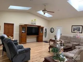 a view of a balcony with chairs and wooden floor
