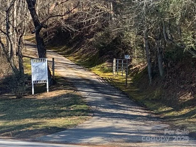a view of a pathway of a house with wooden fence