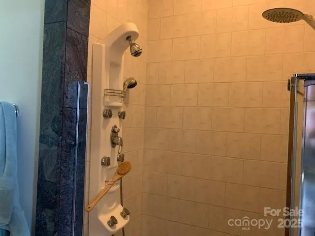 a bed room with a bed mirror and a chandelier