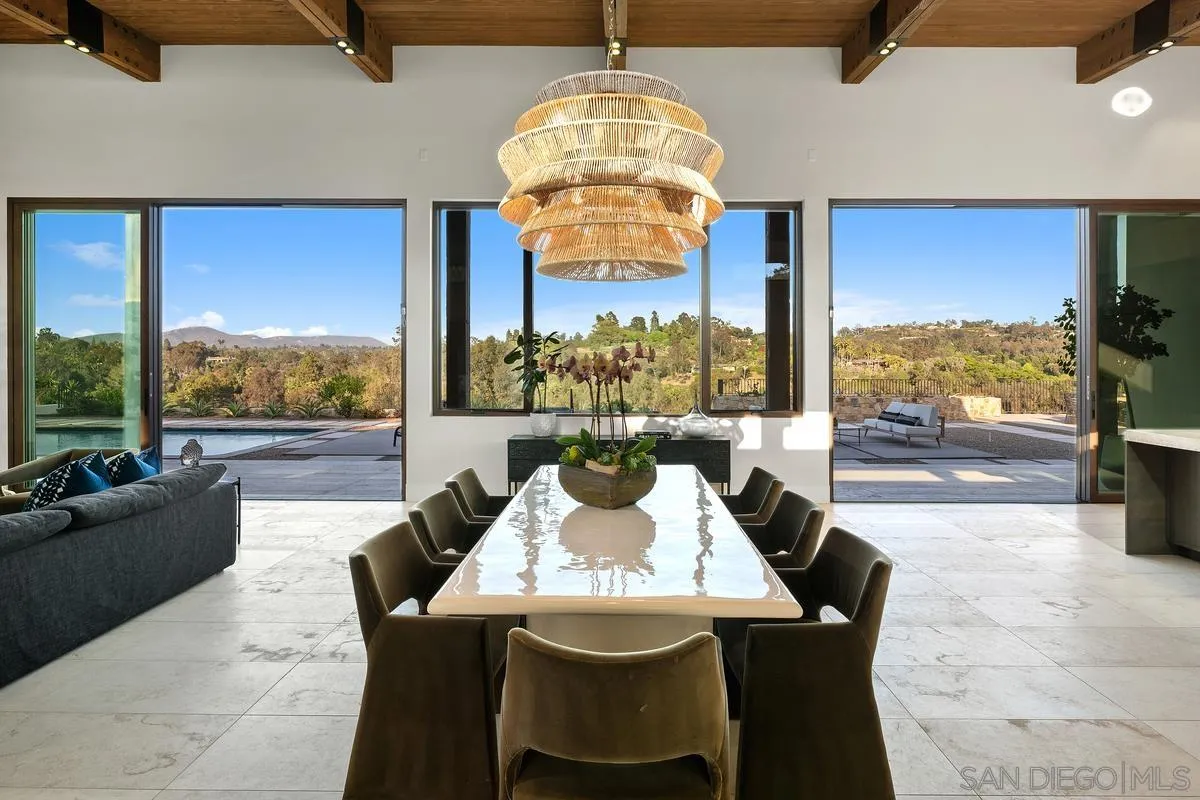 4728 El Aspecto Rancho Santa Fe, CA 92067 - Photo 11 of 34 a view of a dining room with furniture large windows and wooden floor