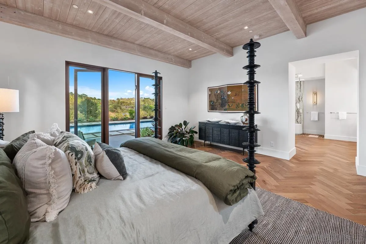 4728 El Aspecto Rancho Santa Fe, CA 92067 - Photo 18 of 34 a bed room with a bed television and a large window