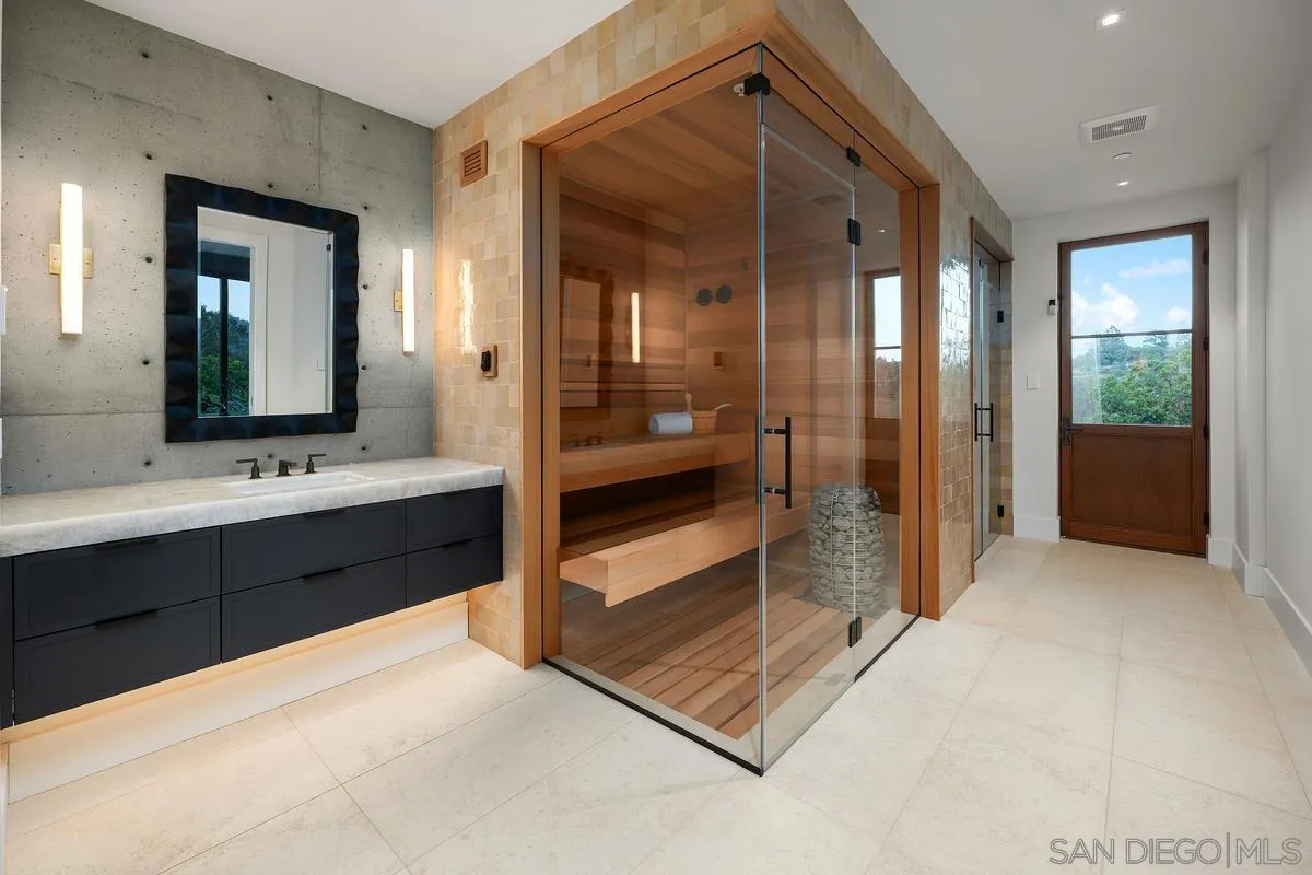 4728 El Aspecto Rancho Santa Fe, CA 92067 - Photo 25 of 34 a spacious bathroom with a shower a sink and a mirror