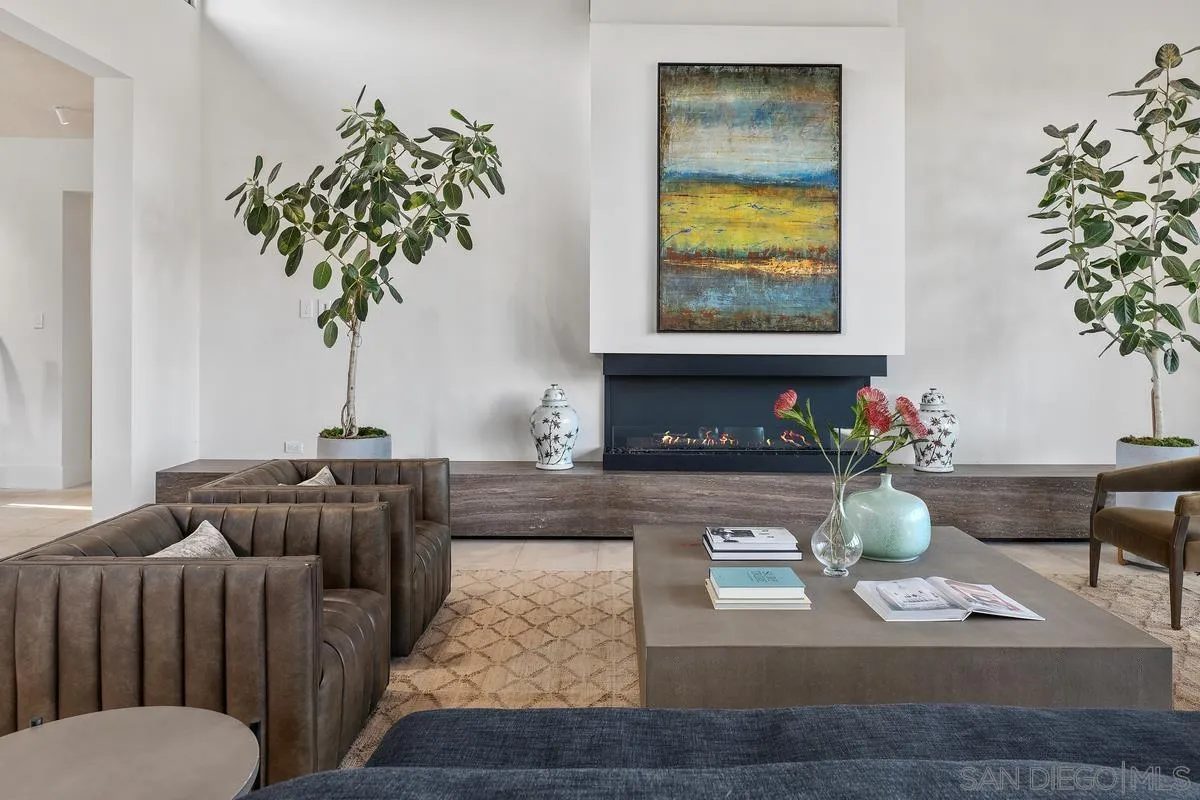 4728 El Aspecto Rancho Santa Fe, CA 92067 - Photo 7 of 34 a living room with furniture potted plant and a fireplace