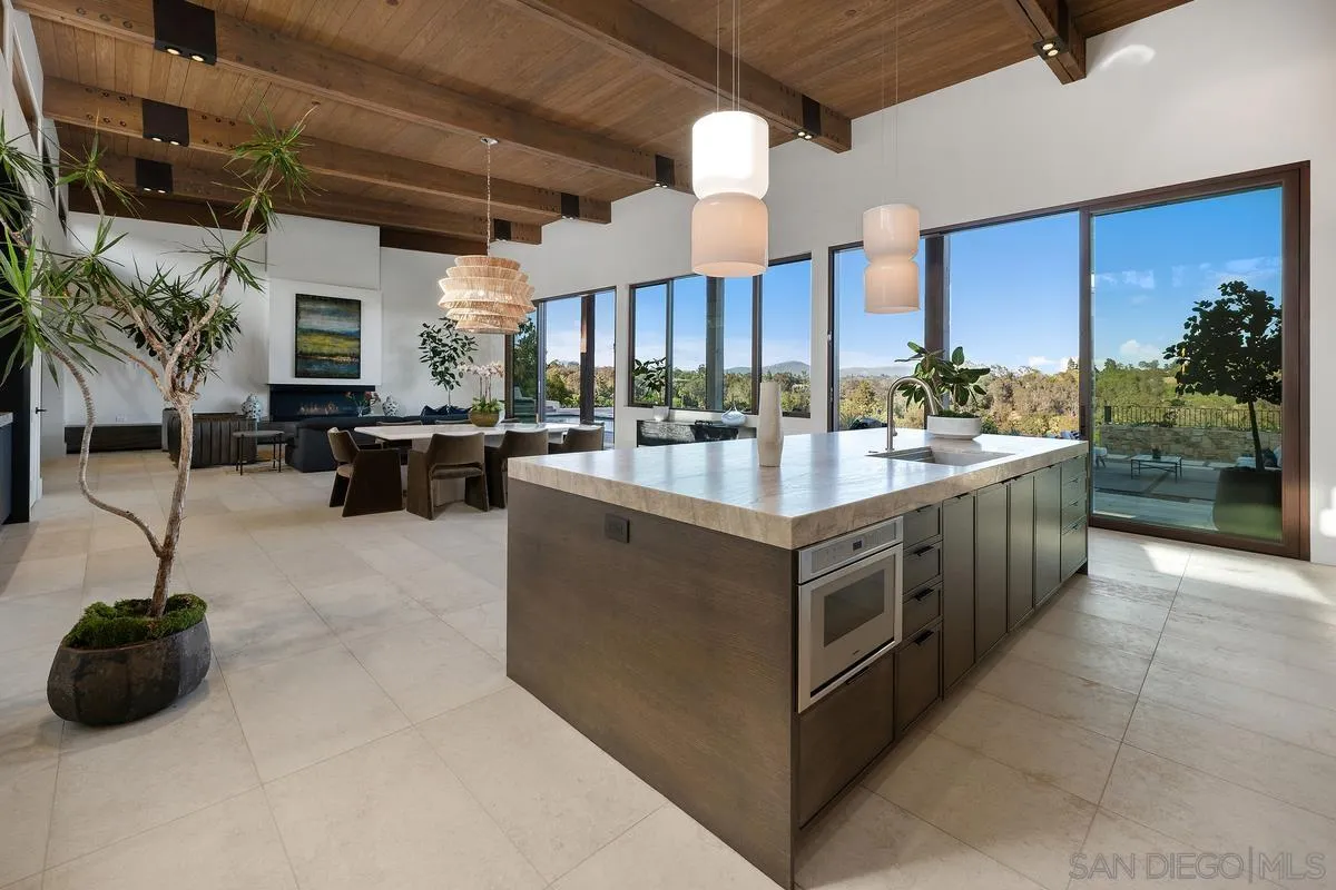 4728 El Aspecto Rancho Santa Fe, CA 92067 - Photo 8 of 34 a kitchen with counter top space and living room view
