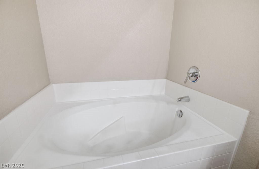 10550 West Alexander Road, Unit 2133 Las Vegas, NV 89129 - Photo 31 of 42 Relax in the deep soaking tub, perfect for unwinding after a long day.