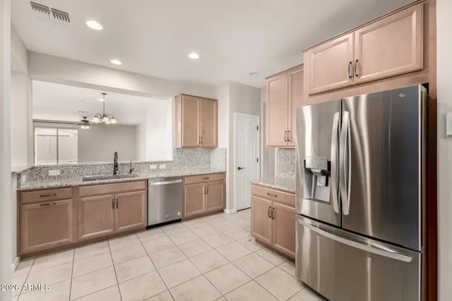 a kitchen with granite countertop stainless steel appliances and white cabinets