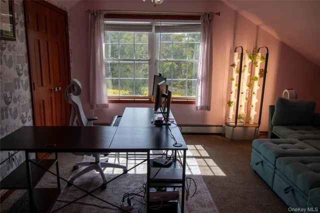 a living room with furniture a window and a flat screen tv