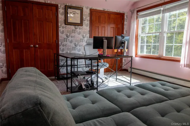 a living room with furniture a fireplace and a window