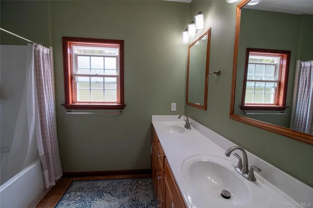 a bathroom with a granite countertop shower and a toilet