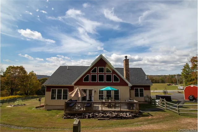 a front view of a house with yard and lake view