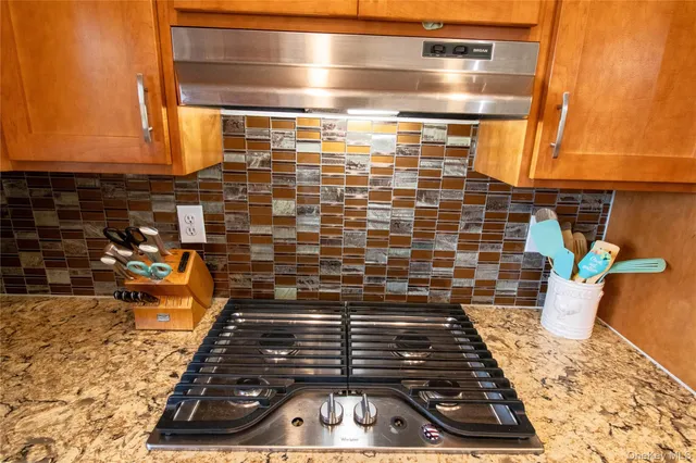 a kitchen with stainless steel appliances granite countertop sink stove and cabinets