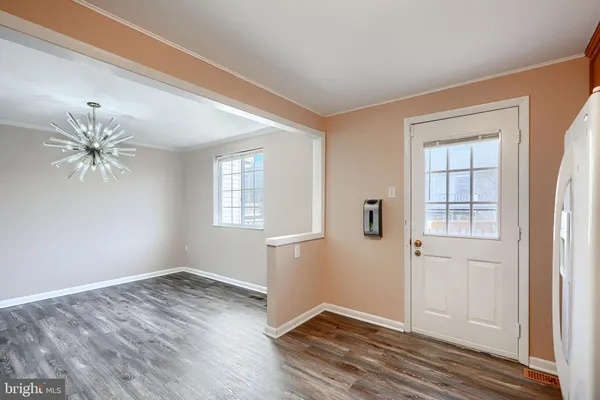 an empty room with wooden floor and a window
