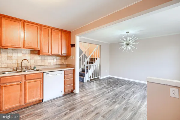 a kitchen with granite countertop a stove a sink and a refrigerator