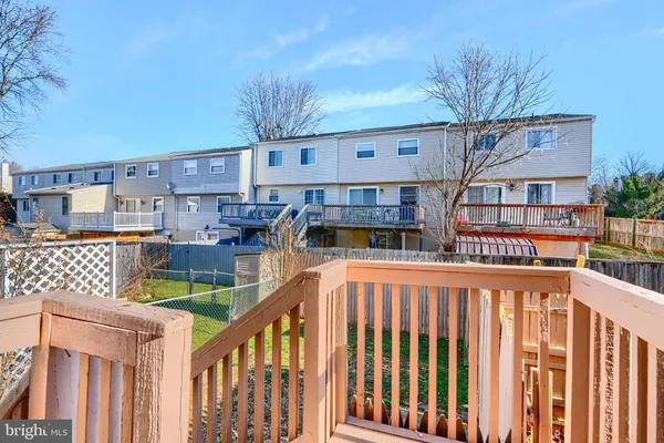 a balcony view with couple of cars parked