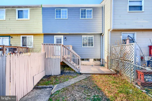 a view of a house with wooden deck front of house