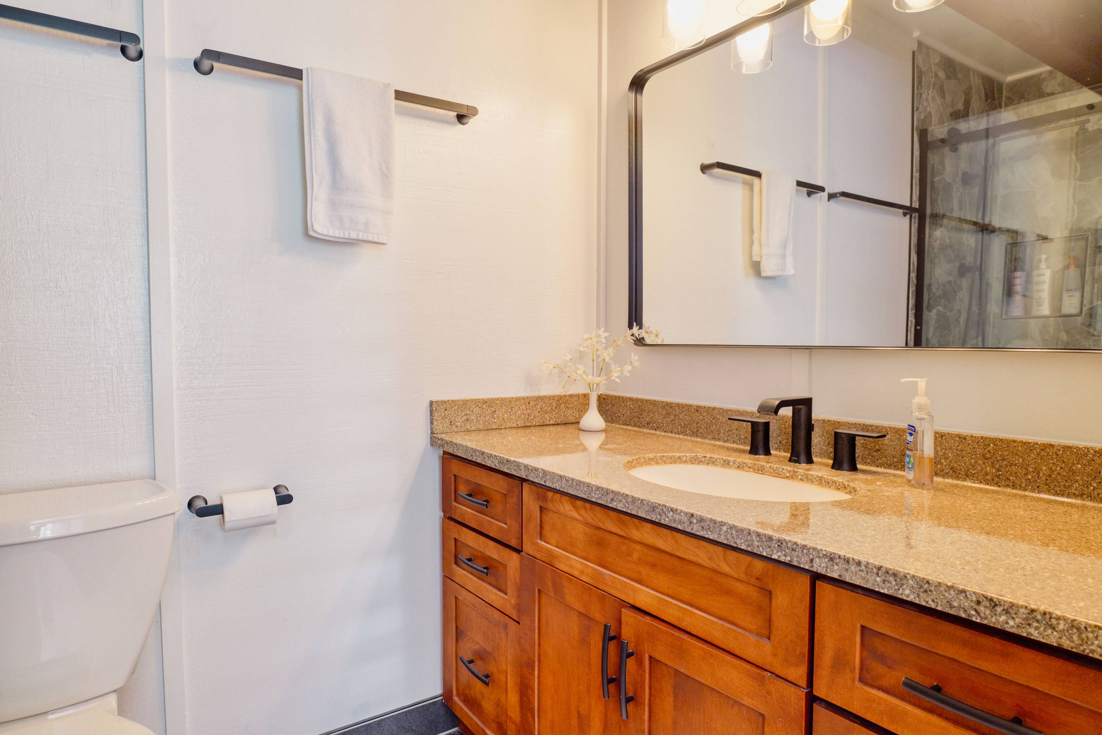 3920 Wyllie Road, Unit F20 Princeville, HI 96722 - Photo 11 of 25 a bathroom with a granite countertop sink and a mirror