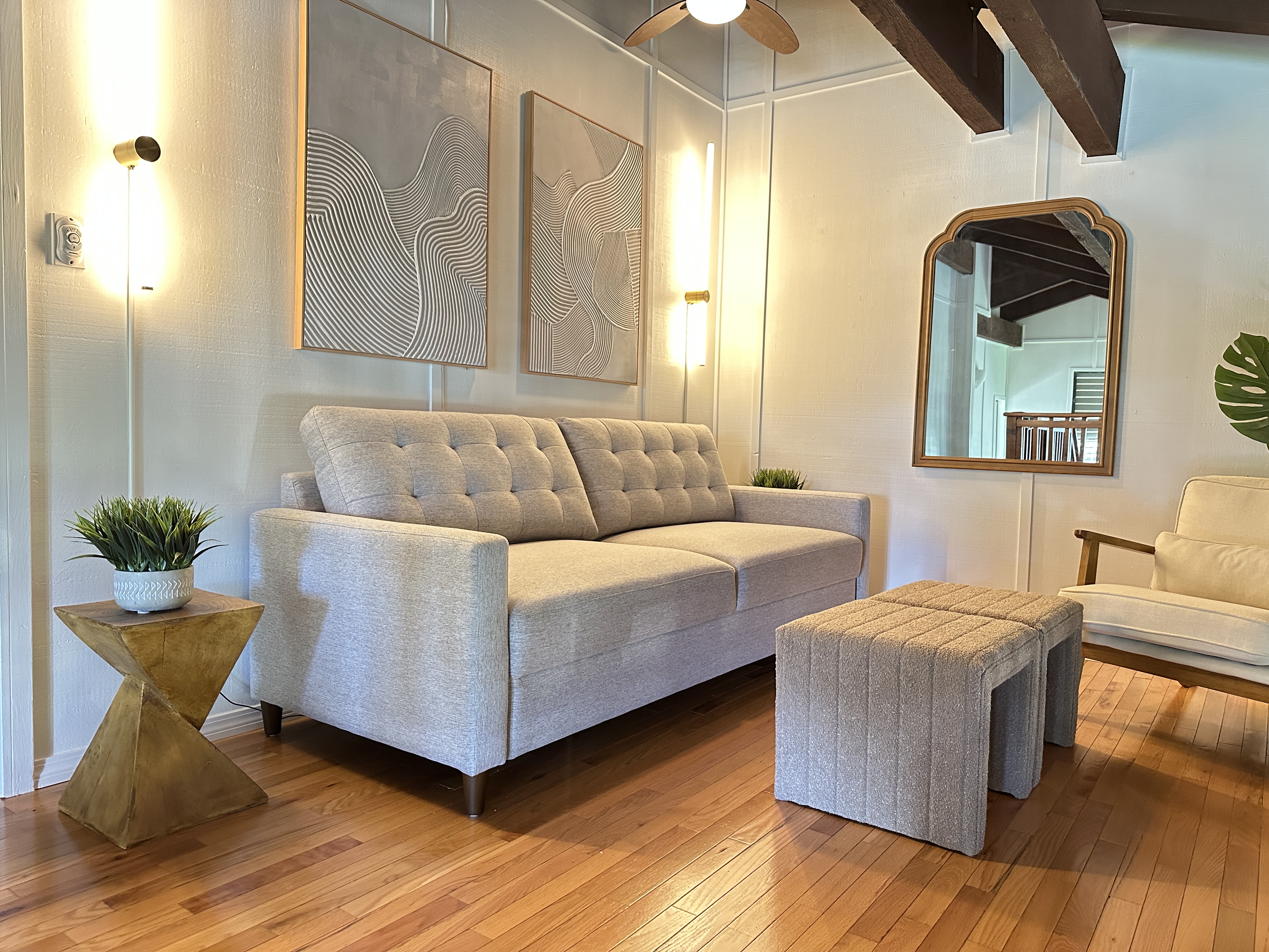 3920 Wyllie Road, Unit F20 Princeville, HI 96722 - Photo 15 of 25 a living room with couches and potted plant with wooden floor