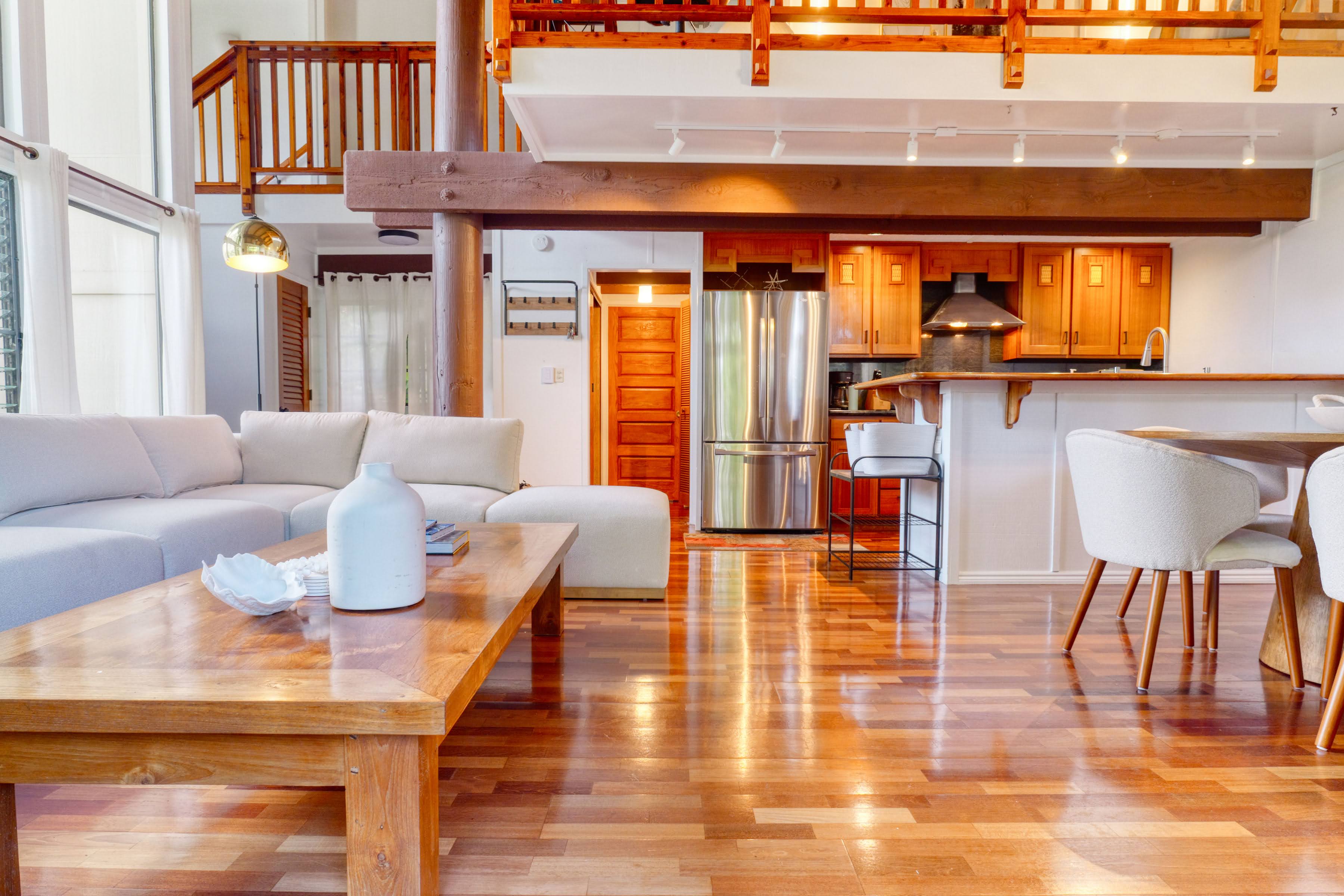 3920 Wyllie Road, Unit F20 Princeville, HI 96722 - Photo 2 of 25 a living room with furniture a rug and a floor to ceiling window