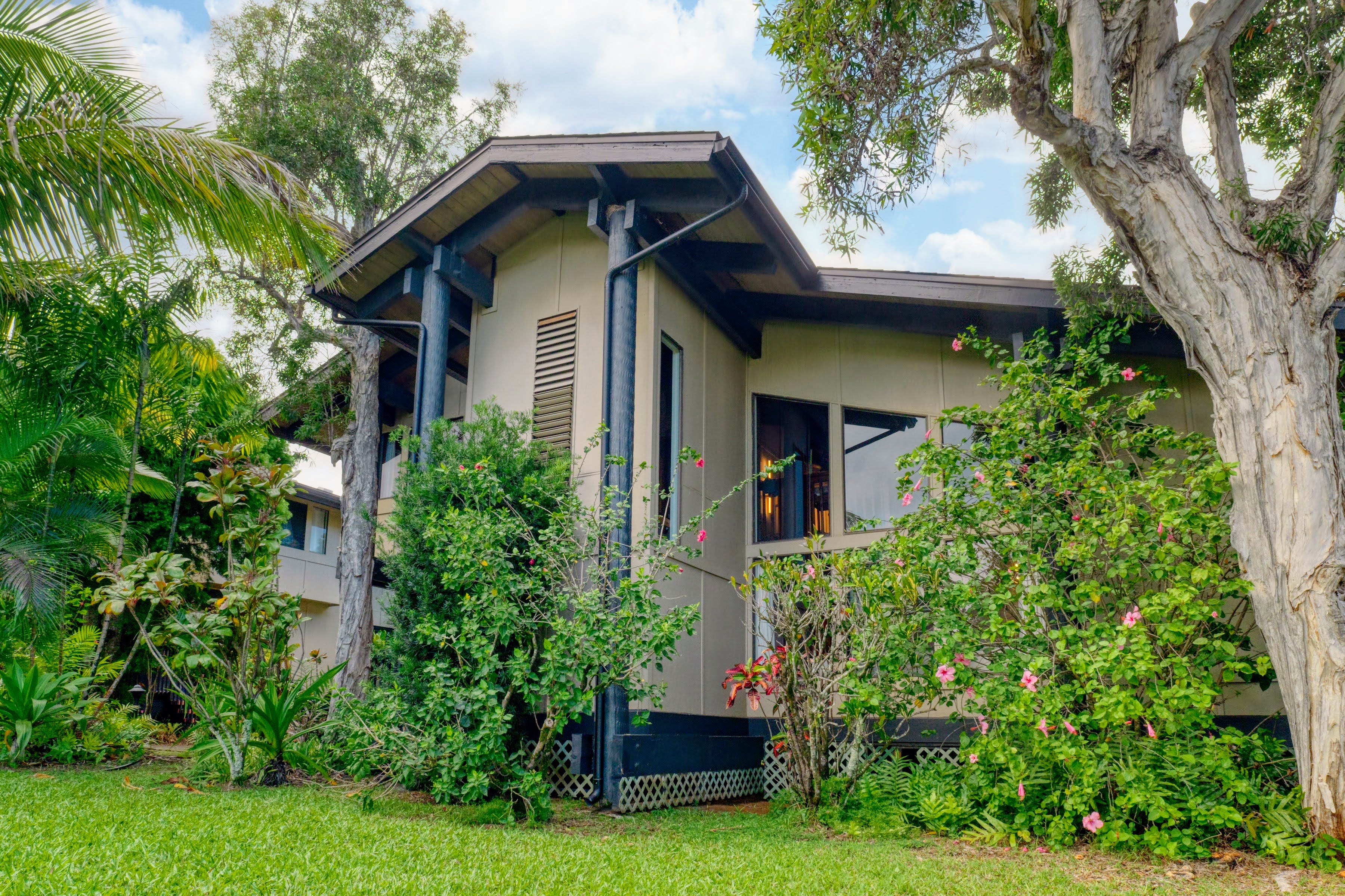 3920 Wyllie Road, Unit F20 Princeville, HI 96722 - Photo 21 of 25 a front view of a house with a garden
