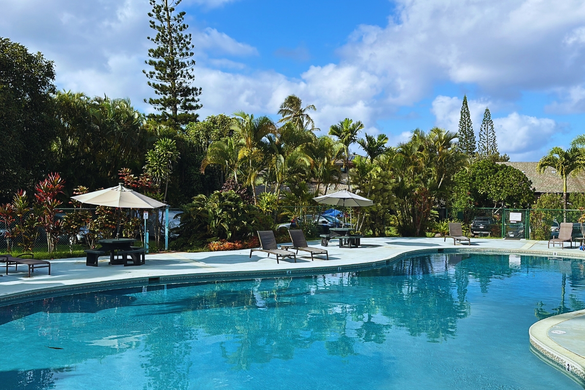 3920 Wyllie Road, Unit F20 Princeville, HI 96722 - Photo 22 of 25 a swimming pool with outdoor seating and yard