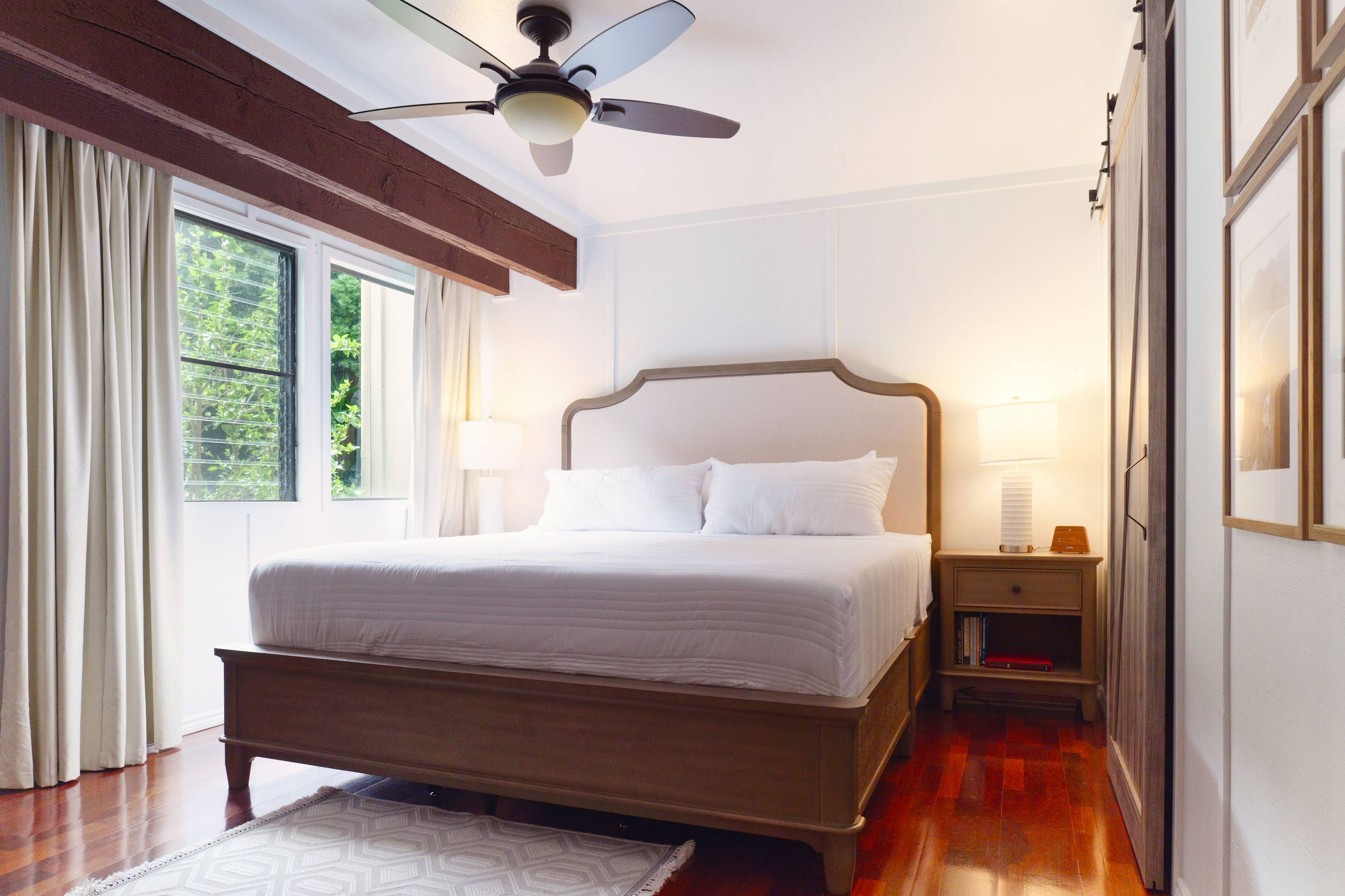 3920 Wyllie Road, Unit F20 Princeville, HI 96722 - Photo 8 of 25 a bedroom with a bed and a large window