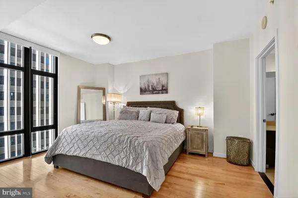 a bedroom with a large bed and painting on the wall