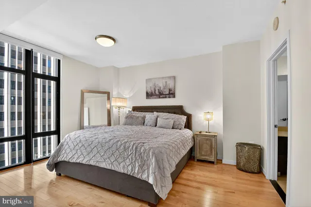 a bedroom with a large bed and painting on the wall