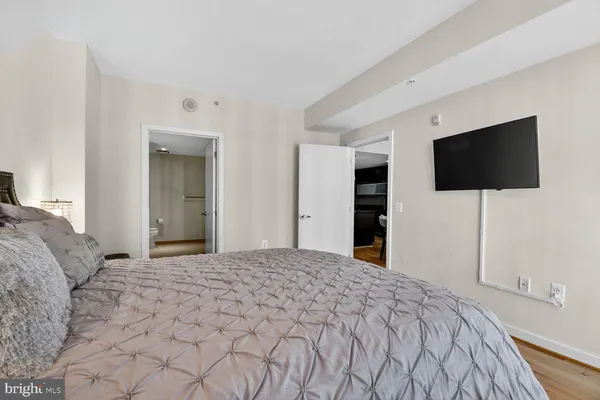 a bedroom with a bed and a flat screen tv