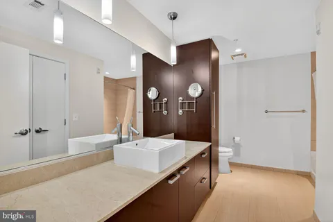 a spacious bathroom with a tub shower and sink
